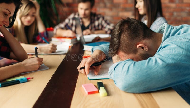 Group of teens studying together happily to prevent exam preparation fatigue.